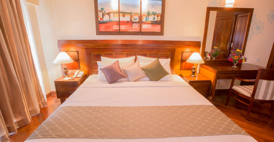 King size beds and comfortable bedding at the Sea View Suite Rooms